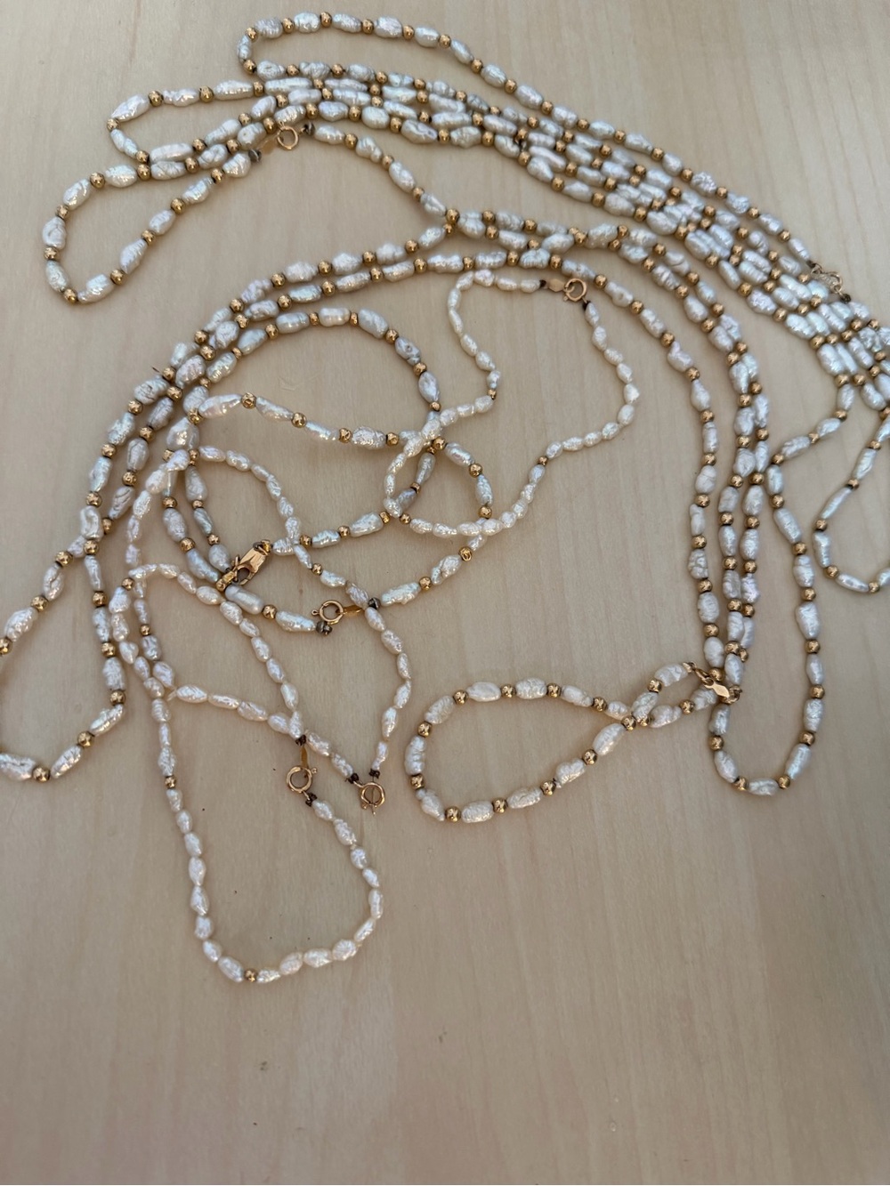 Multiple White Pearl and Gold Bead Long Necklaces and bracelets